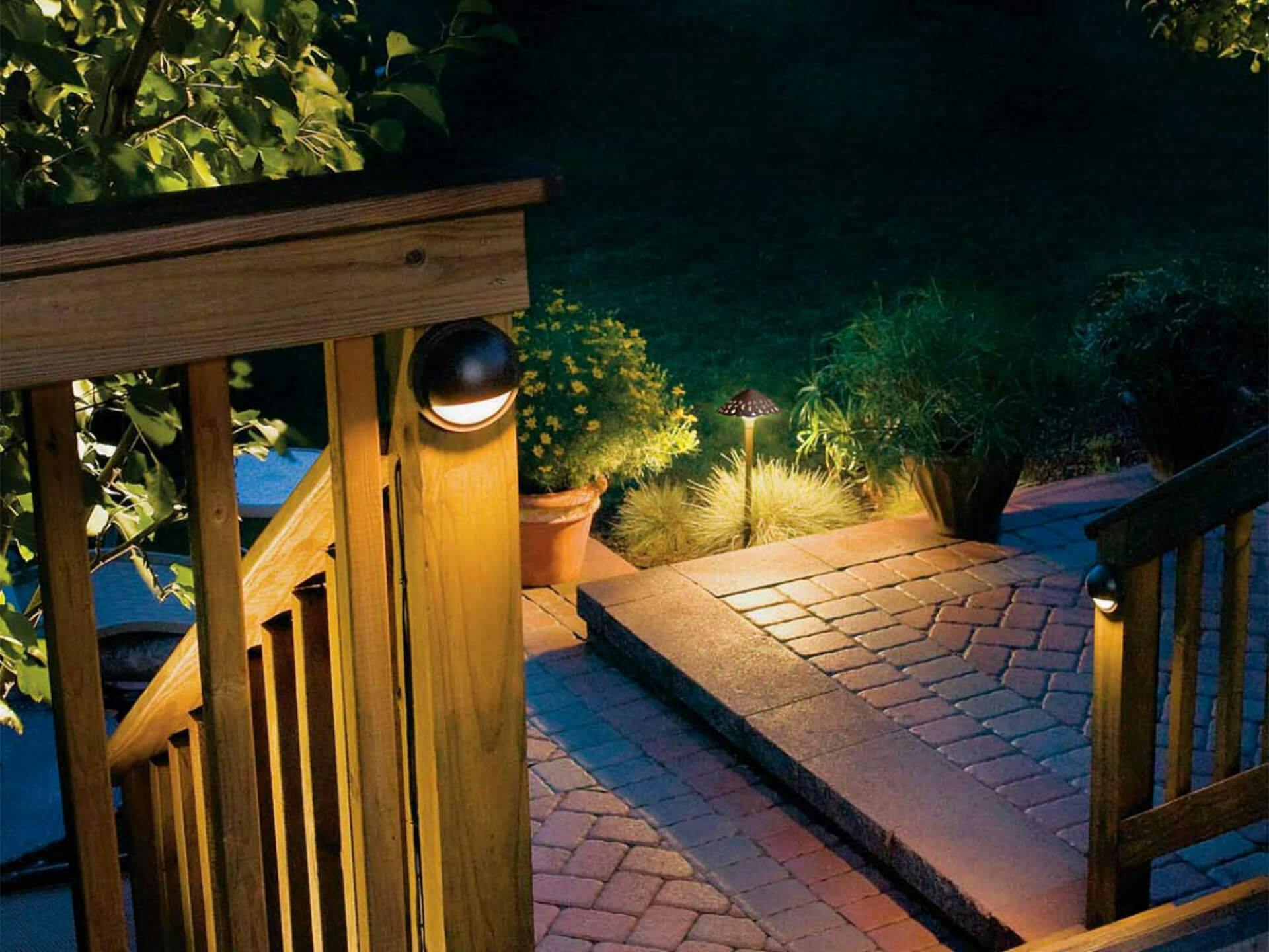 Back patio at night featuring attached lights on the posts