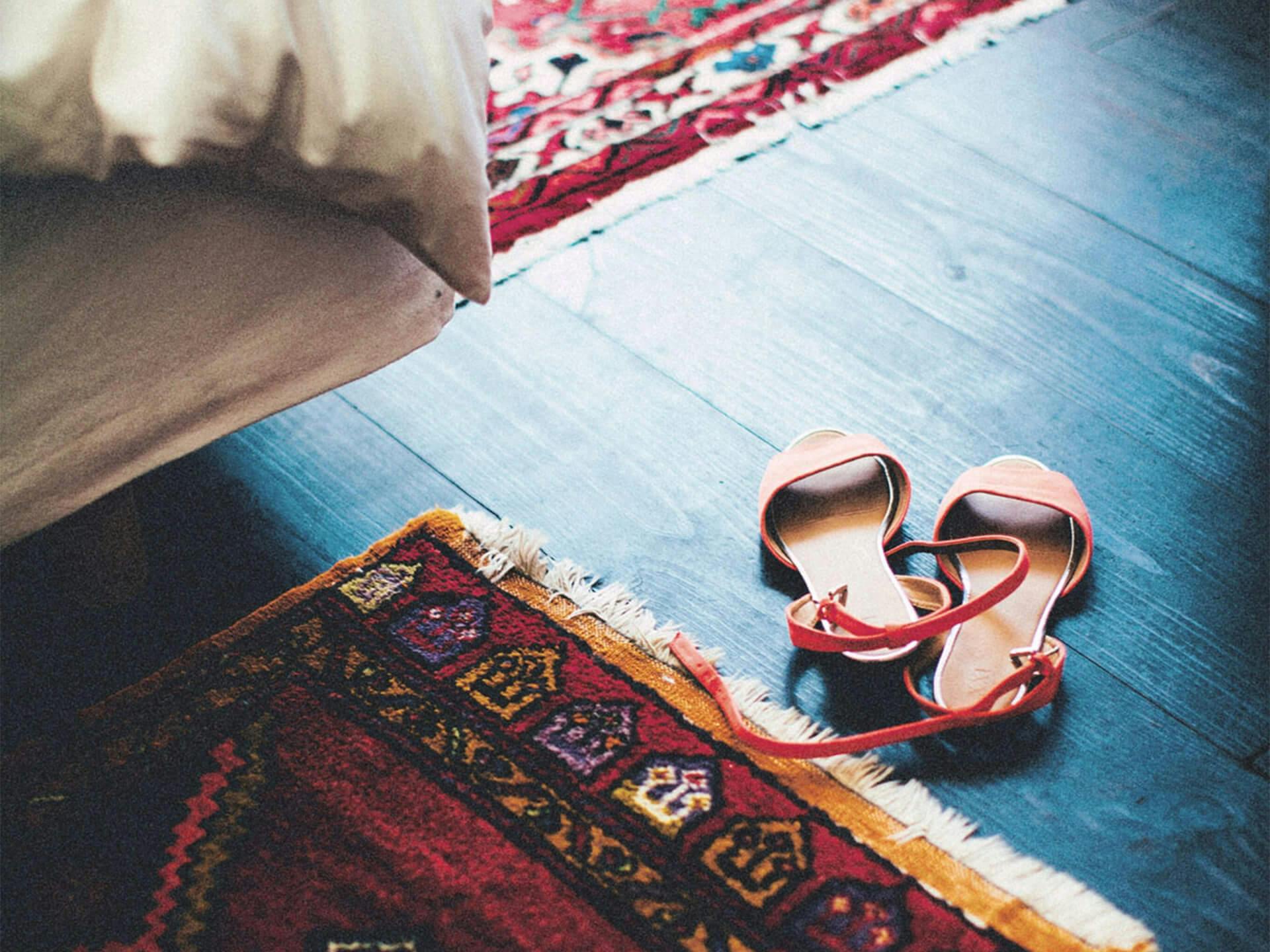 Sandals near a patterned rug