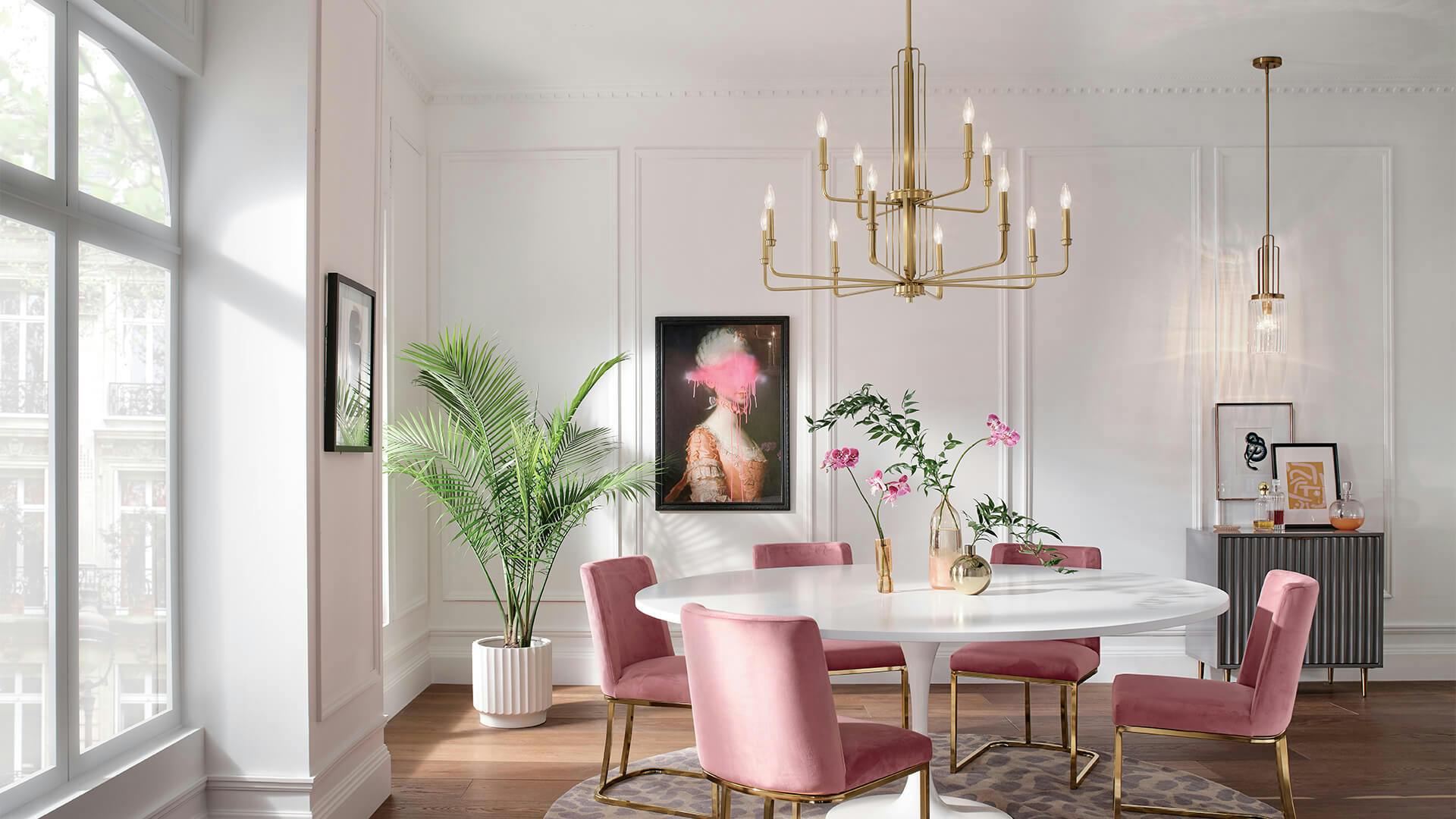 Kimrose chandelier with gold finish hanging over dining room table 