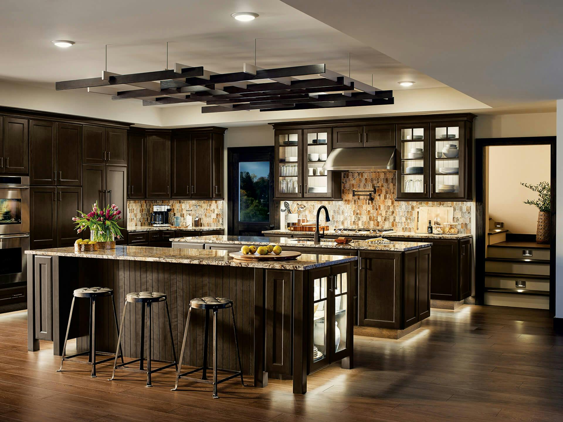 Large multi island kitchen with dark wood cabinets