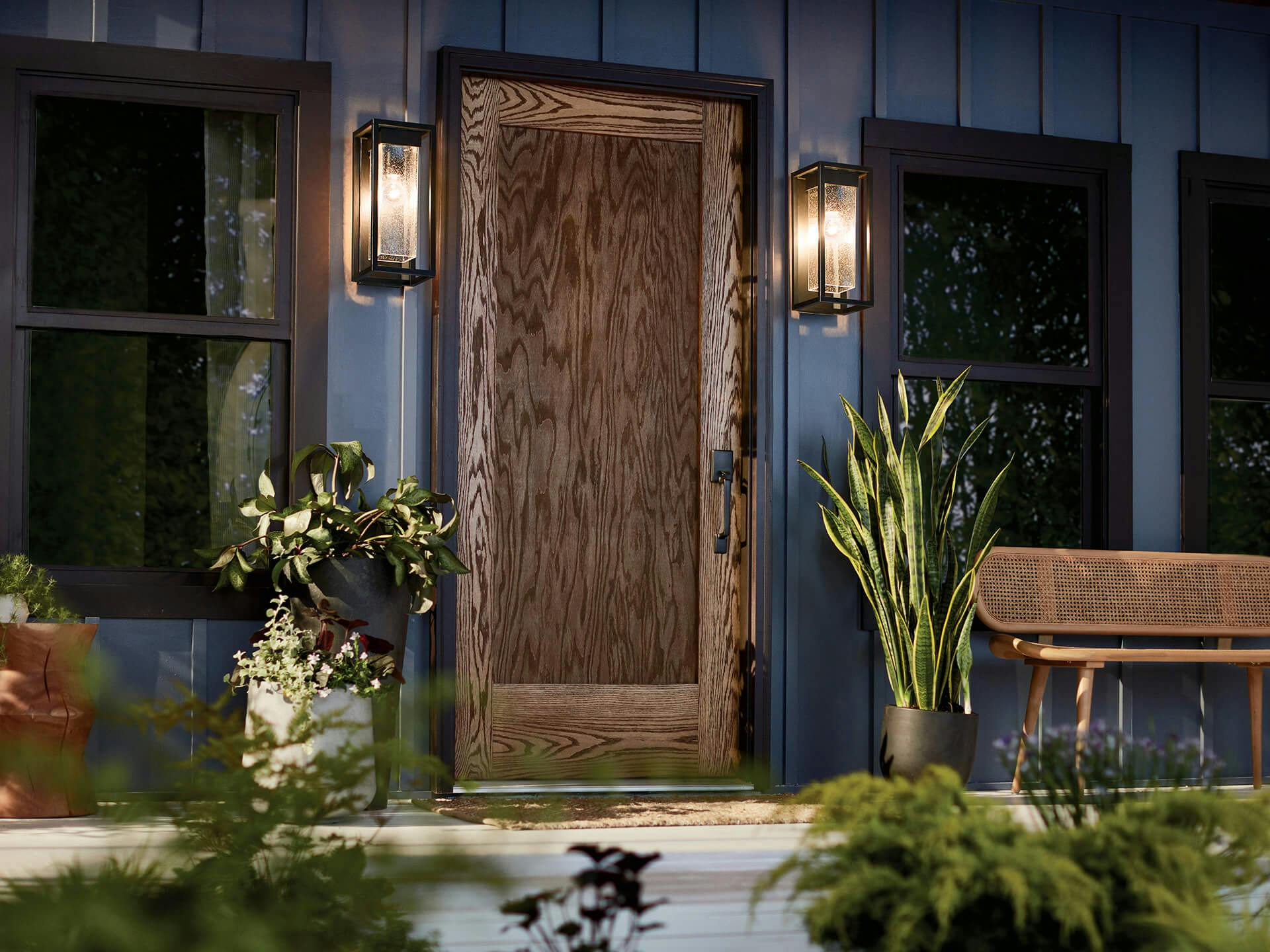 Exterior of a front porch with a rustic wood door and two Mercer black finish sconces