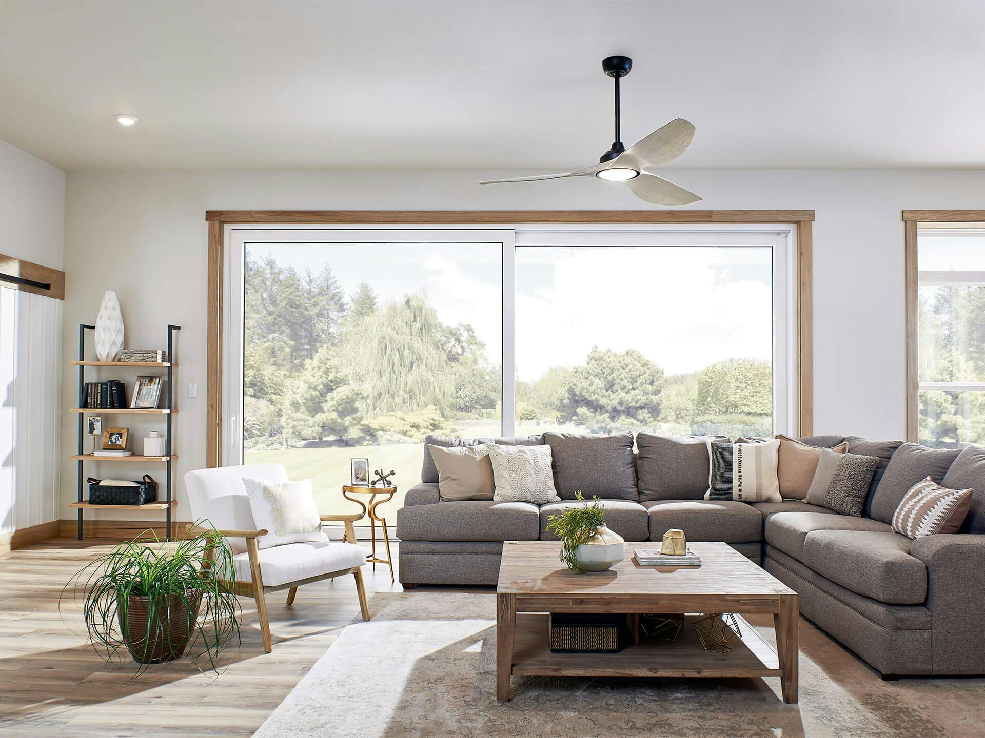 Living room with large windows featuring an Imari ceiling fan