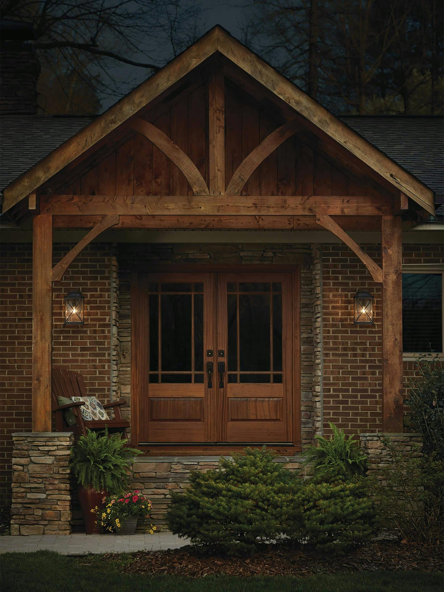 Exterior of a rustic entryway with Argyle sconces on either side of the double front doors