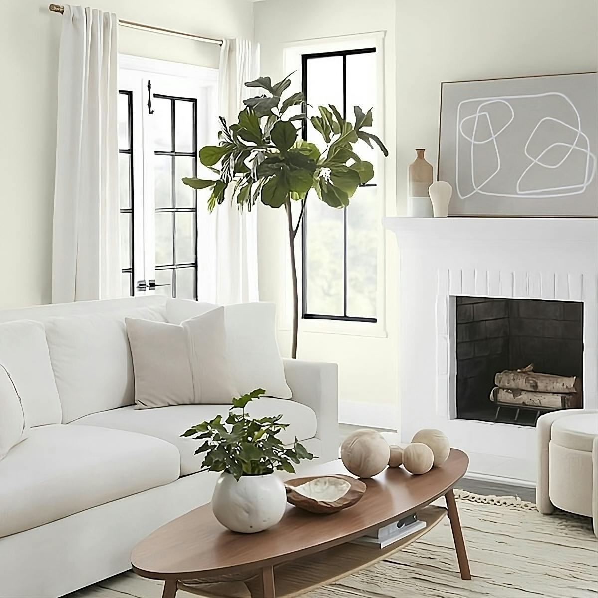 Modern living room setting with fire place, plants and neutral colors. 