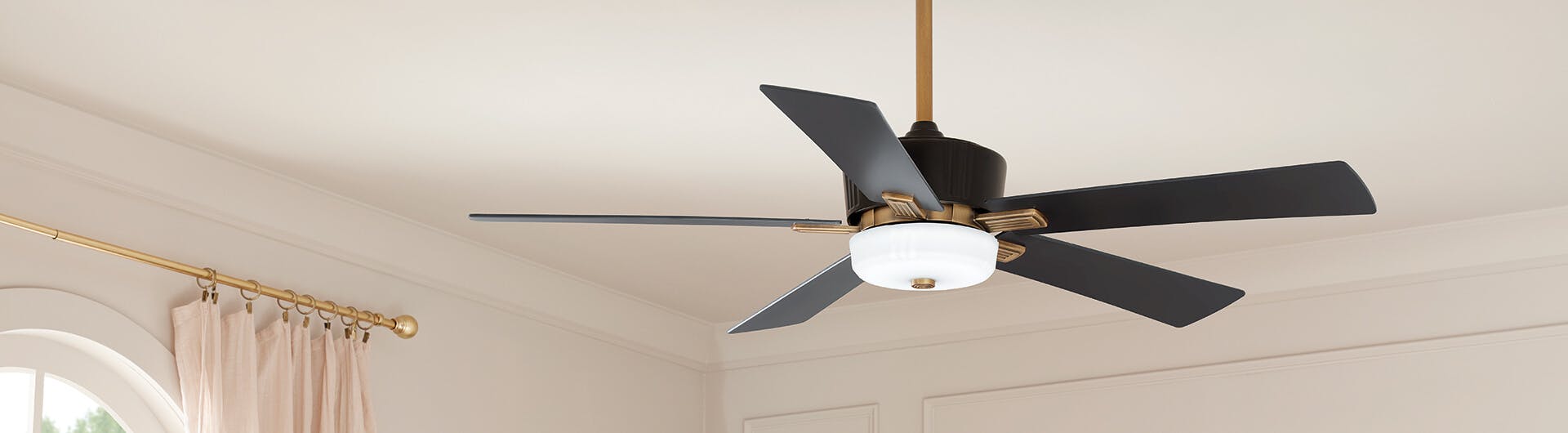 An Icon ceiling fan in satin black hanging in a bedroom
