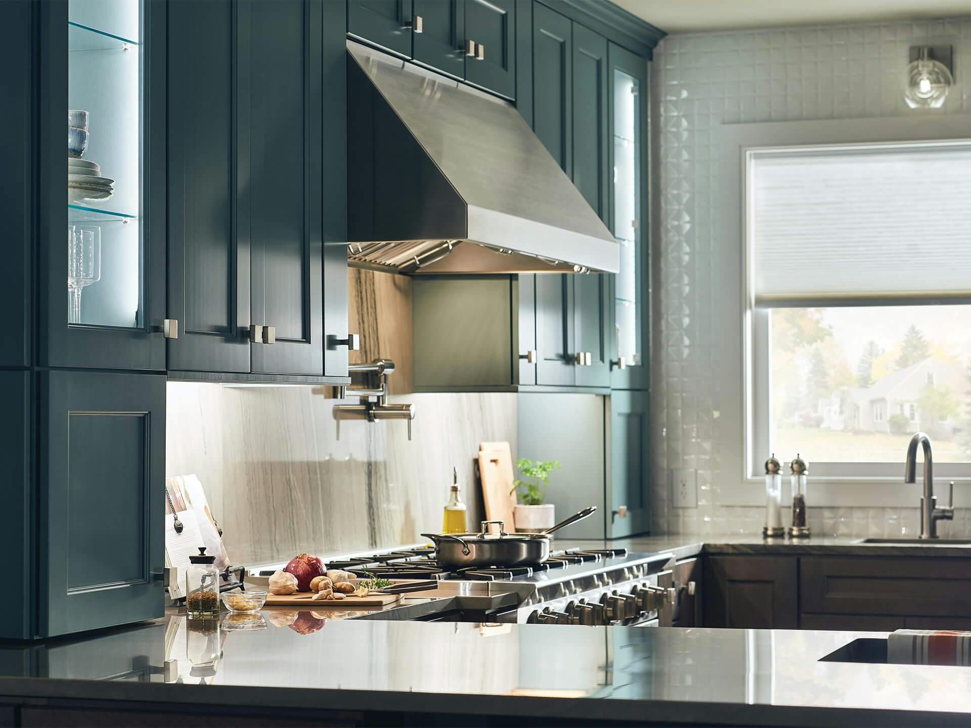 Kitchen setting, centered on the stovetop, with a Harmony wall sconce lighting the wall