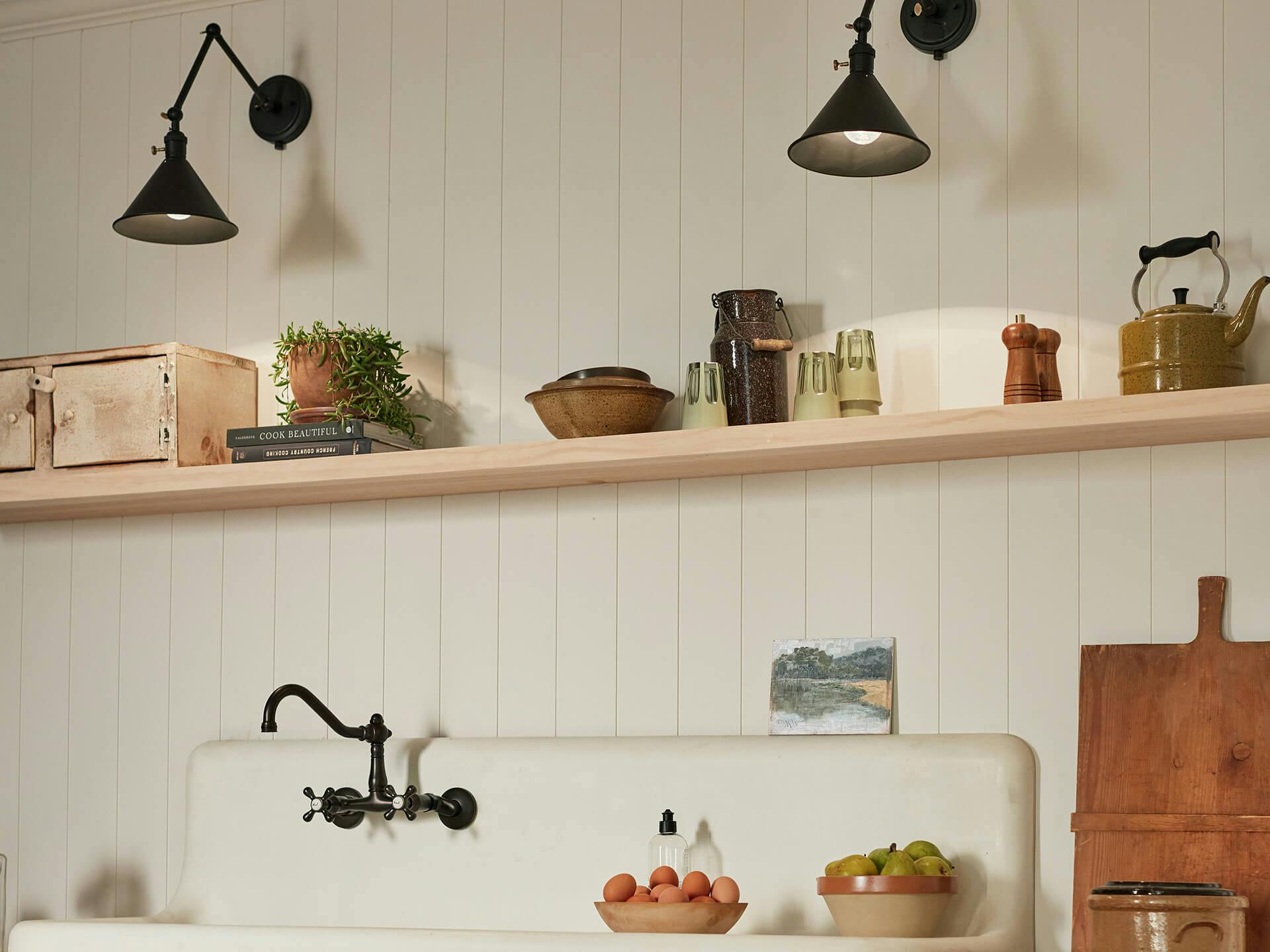 Kitchen wall with farm style sink and two ellerbeck black finish sconces