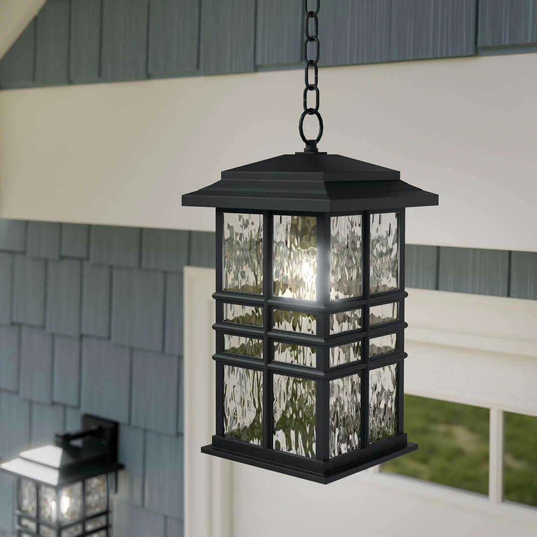 Day time view of the Beacon Square 18" 1-Light Outdoor Hanging Light in Textured Black on the porch of a home