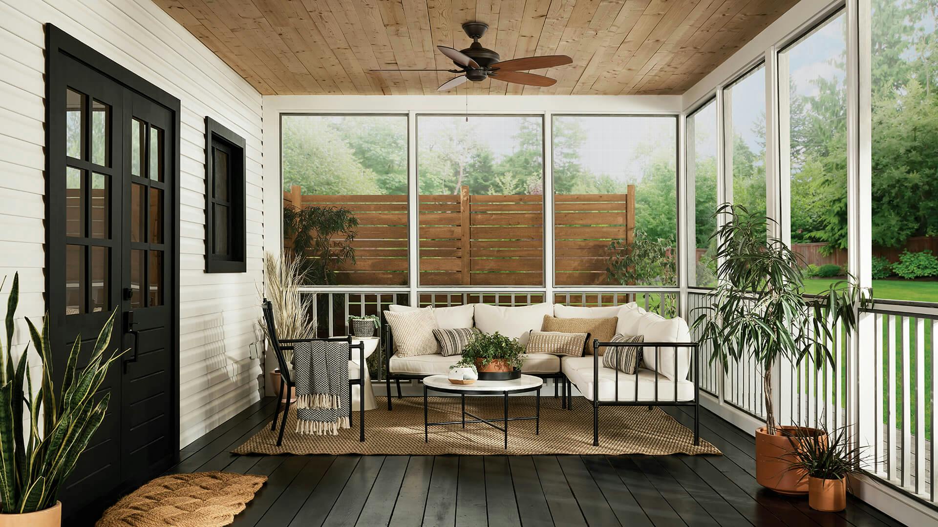 Exterior of a screened in porch with a white cushion porch and featuring a Cabot ceiling fan