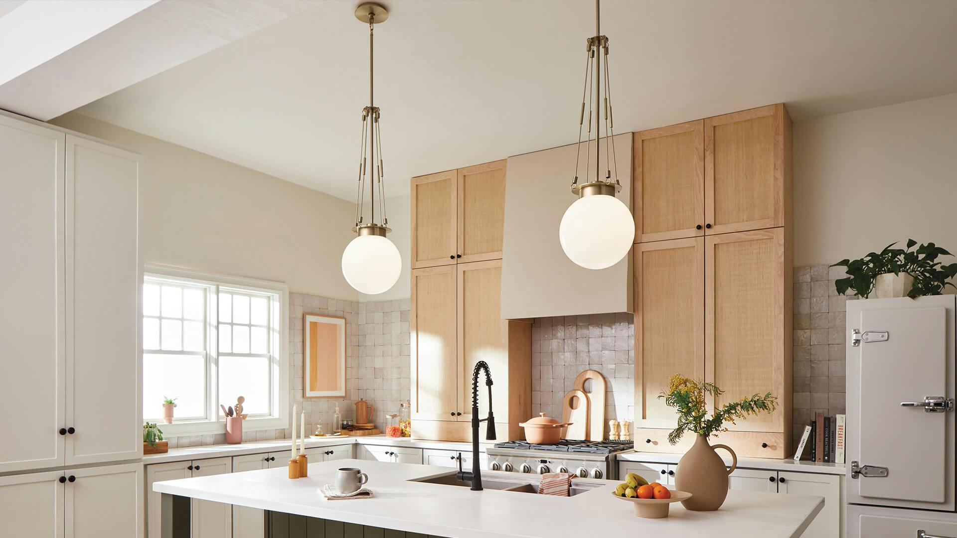Two Albers pendants hanging above a kitchen island in champagne bronze finish