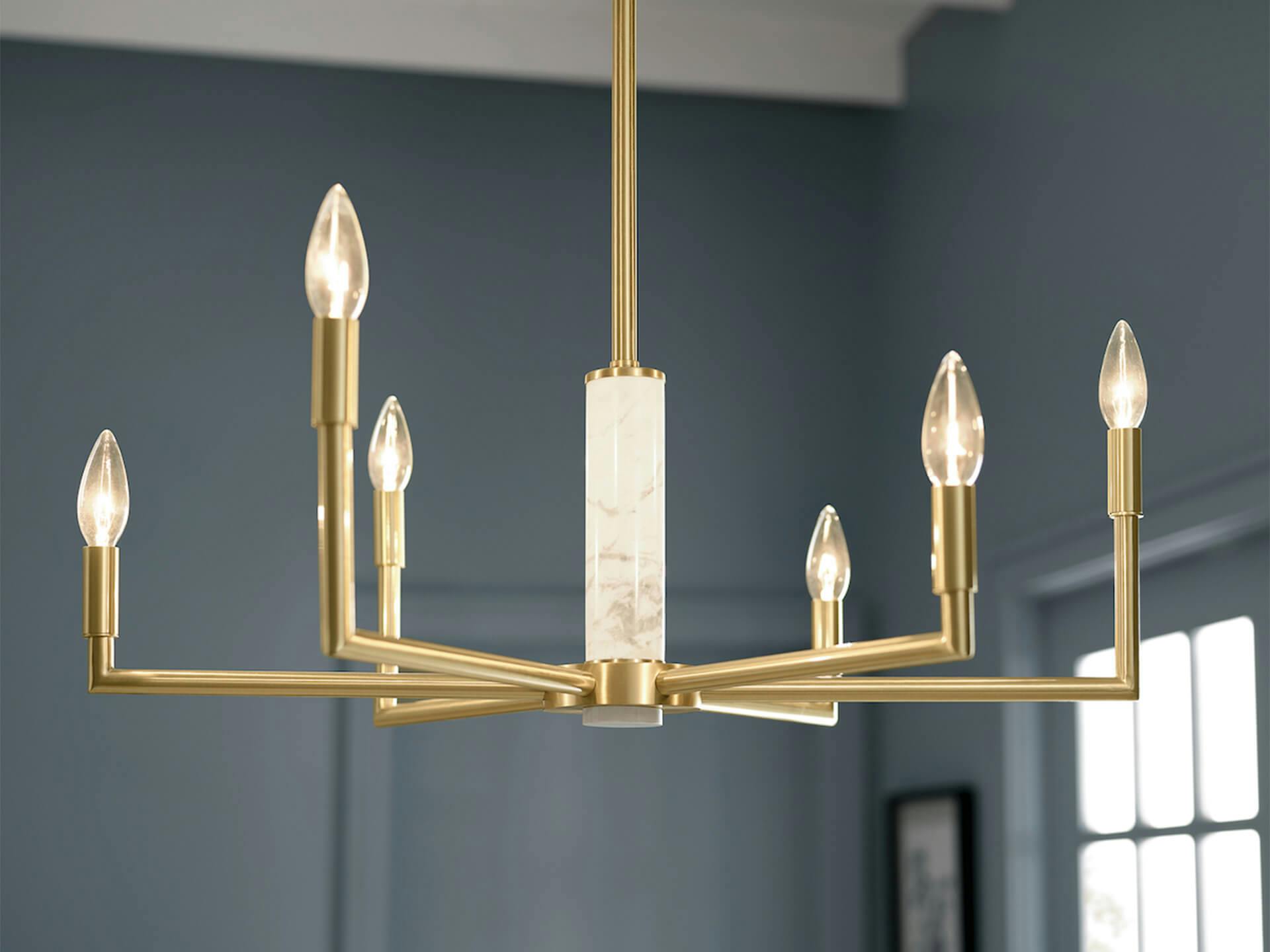 Detail shot of a 6 light Laurent chandelier with a gold finish and white marble detail