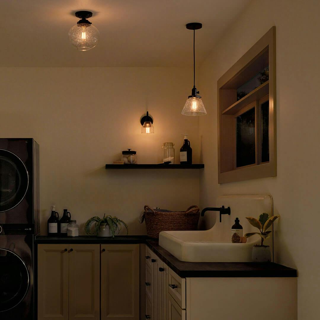 Laundry room at night with the Avery 9 Inch 1 Light Cone Mini Pendant with Clear Seeded Glass in Black