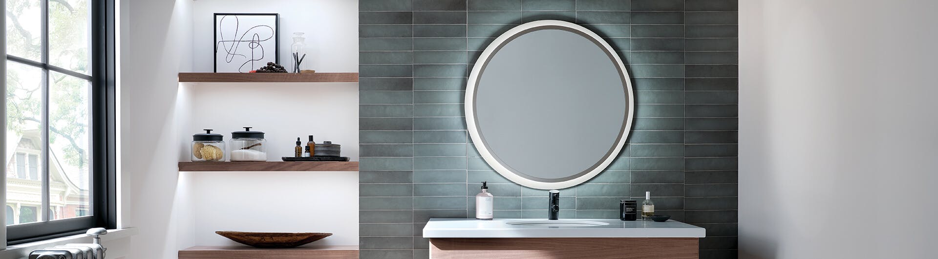 Bathroom during the day featuring a round ryame mirror with LED edge