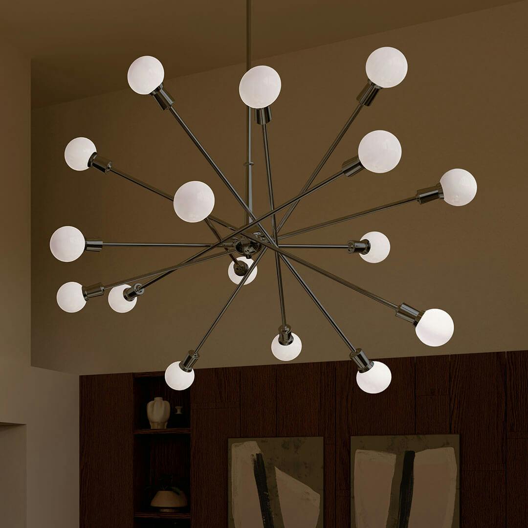 A loungeat nightt with the Armstrong 63" 16 Light Chandelier in Chrome