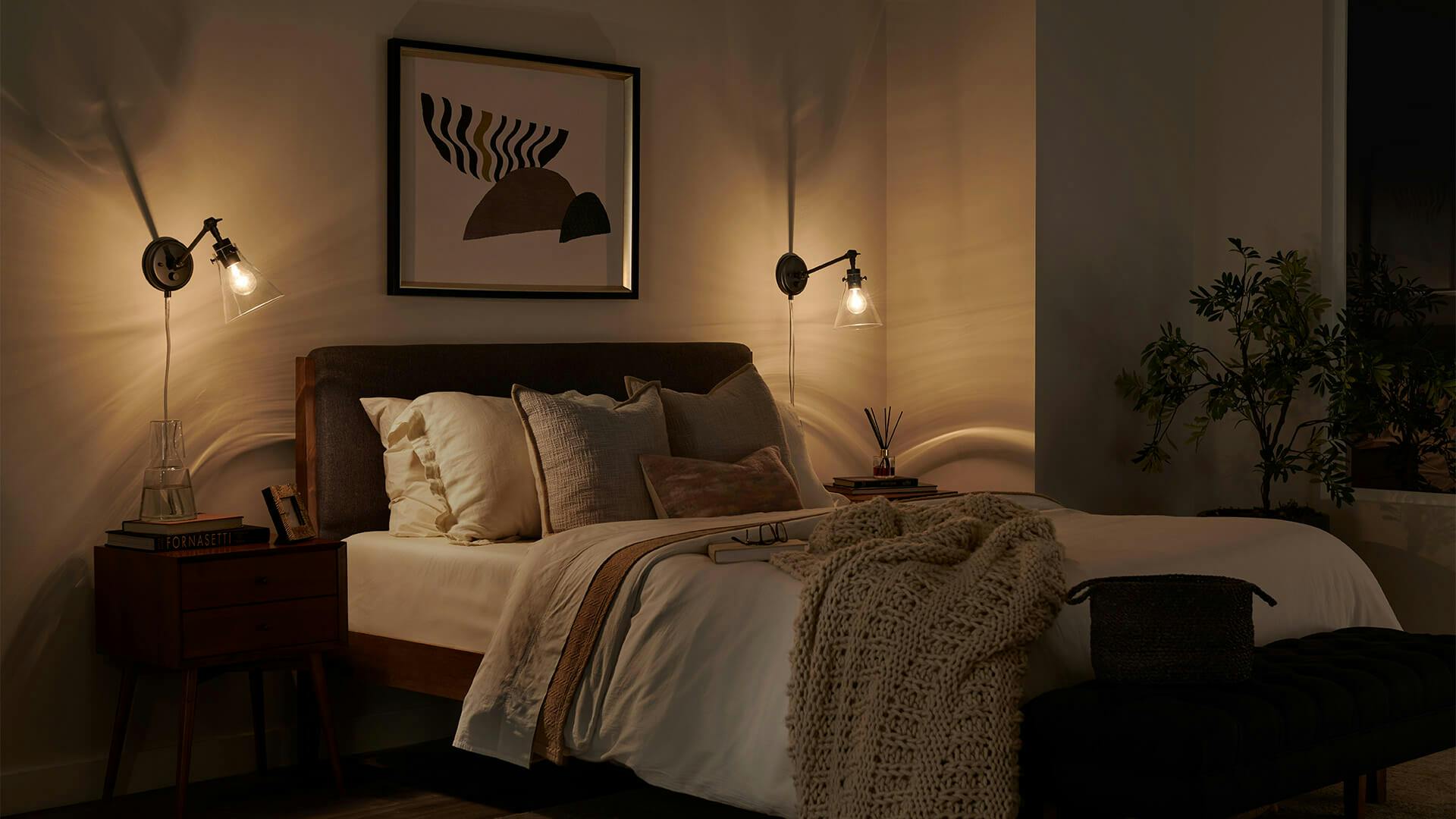 Bedroom in the evening featuring Rosewood sconces