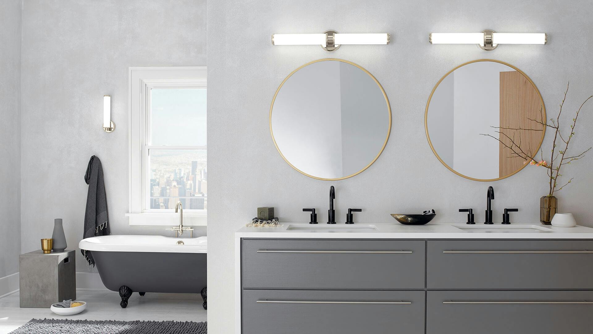 High rise bathroom during the day with two Indeco lights above two round mirrors
