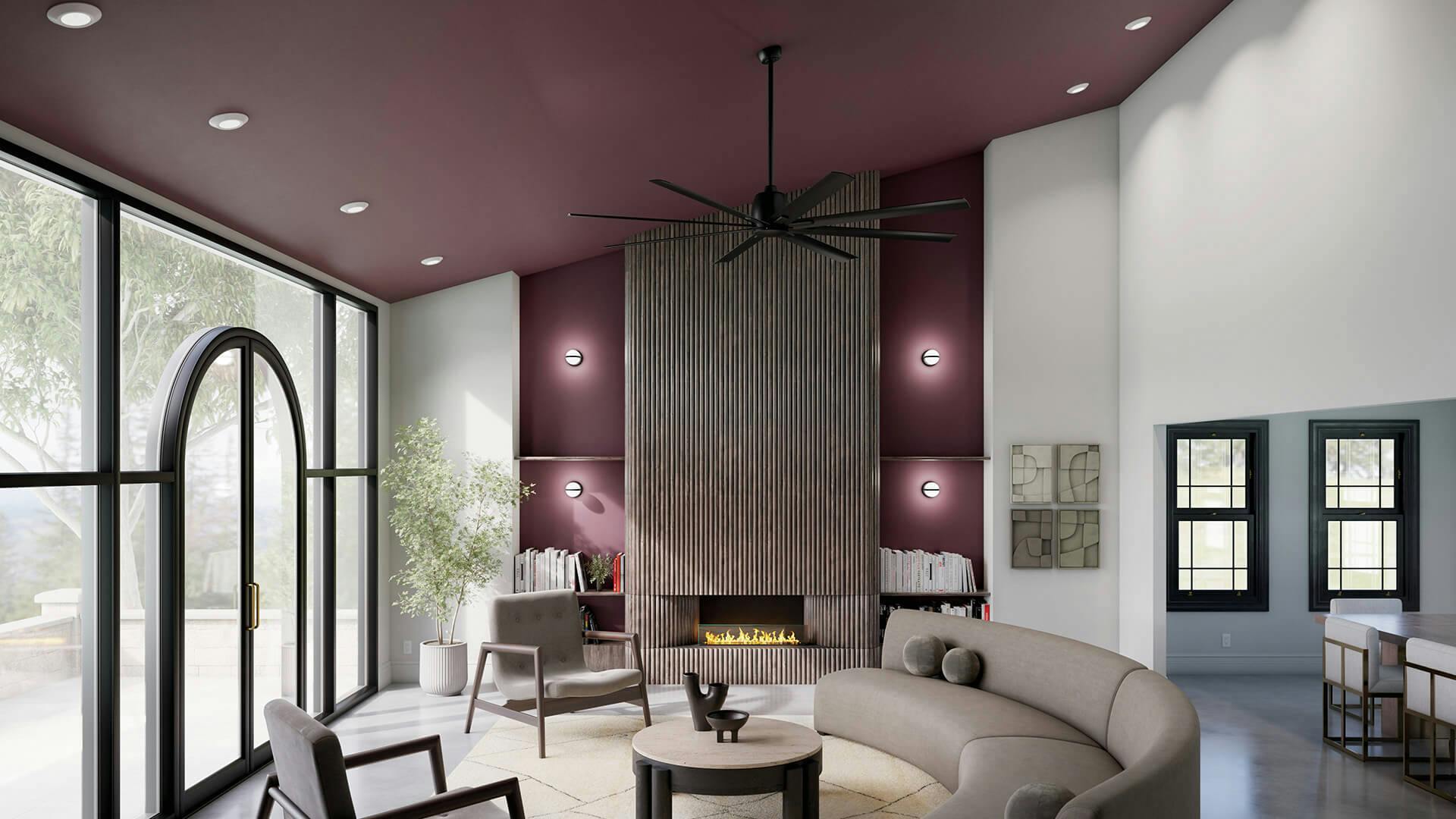 Large living room with mauve ceiling and wall panels with a fireplace featuring a breda ceiling fan.