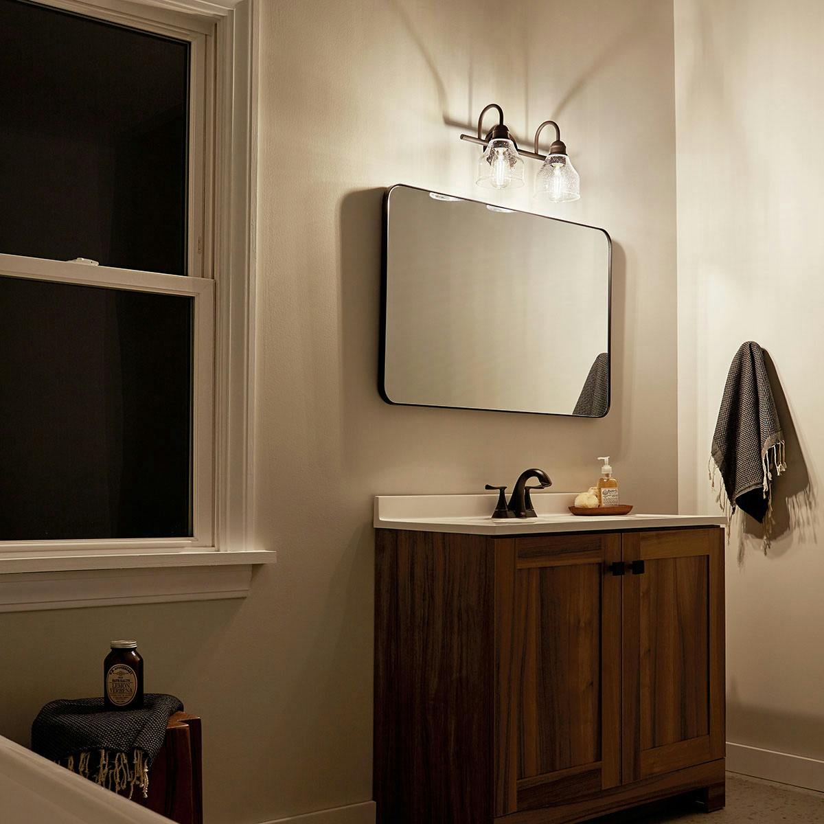 Night time Bathroom featuring Avery vanity light 45972OZ