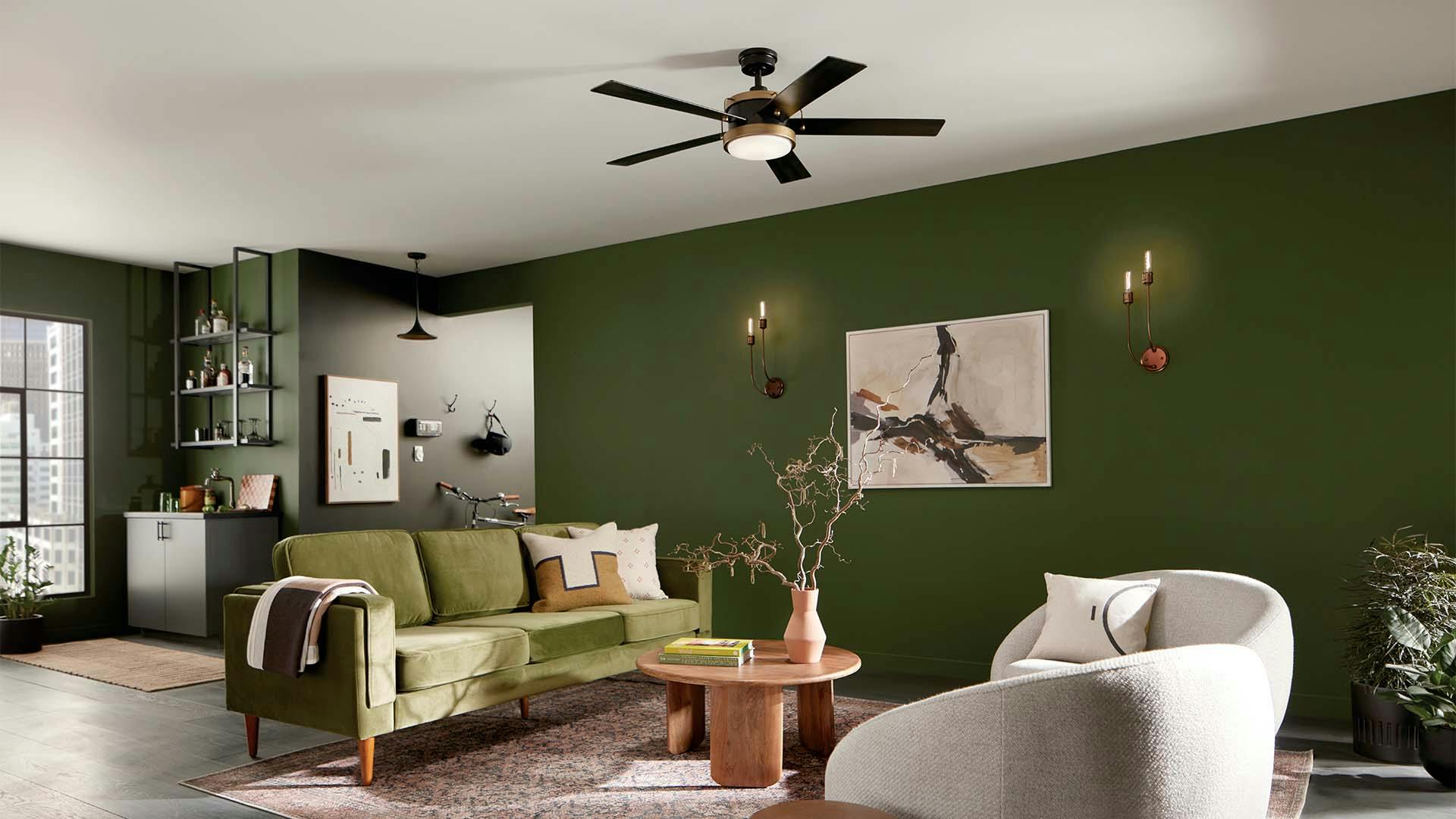 Living room with green walls and couches with a Salvo ceiling fan in center and sconces on wall.