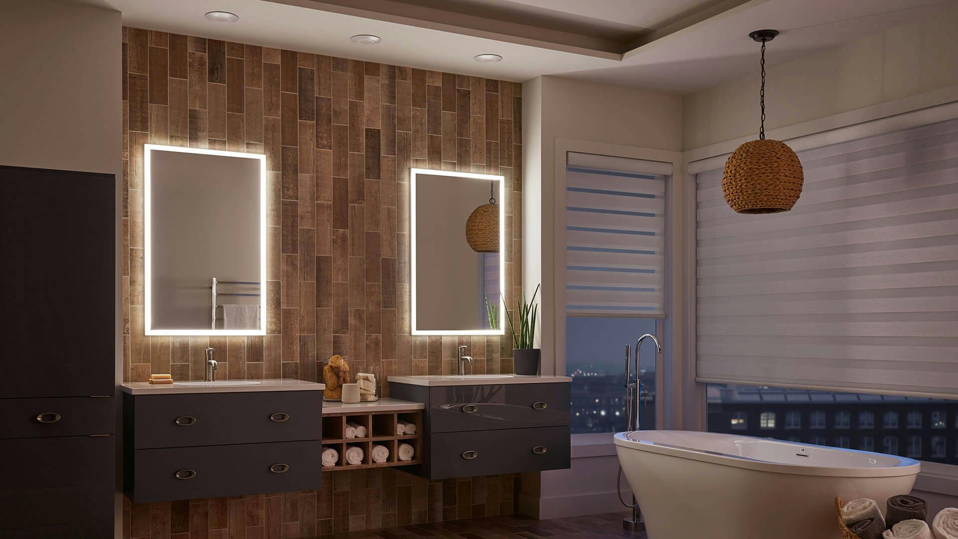 Bathroom lit by two LED backlit mirrors above the sinks