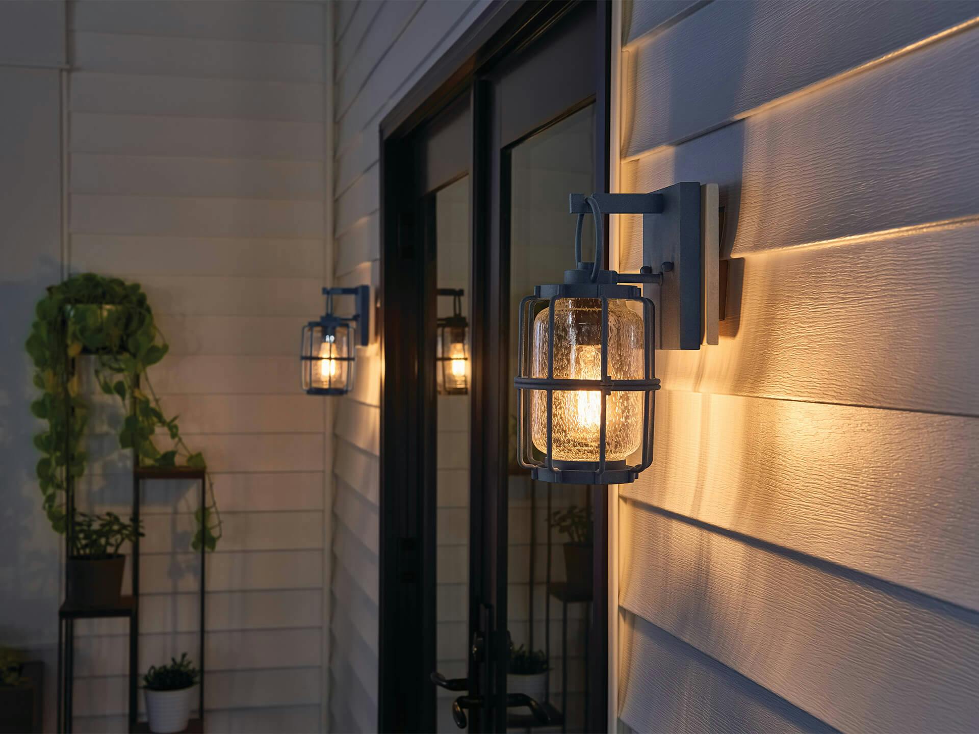 Exterior image of a back porch lit with Montview exterior wall lights at night 