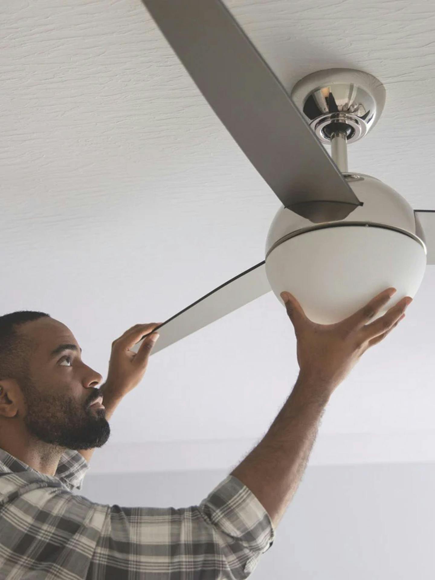 Contractor installing ceiling fan.