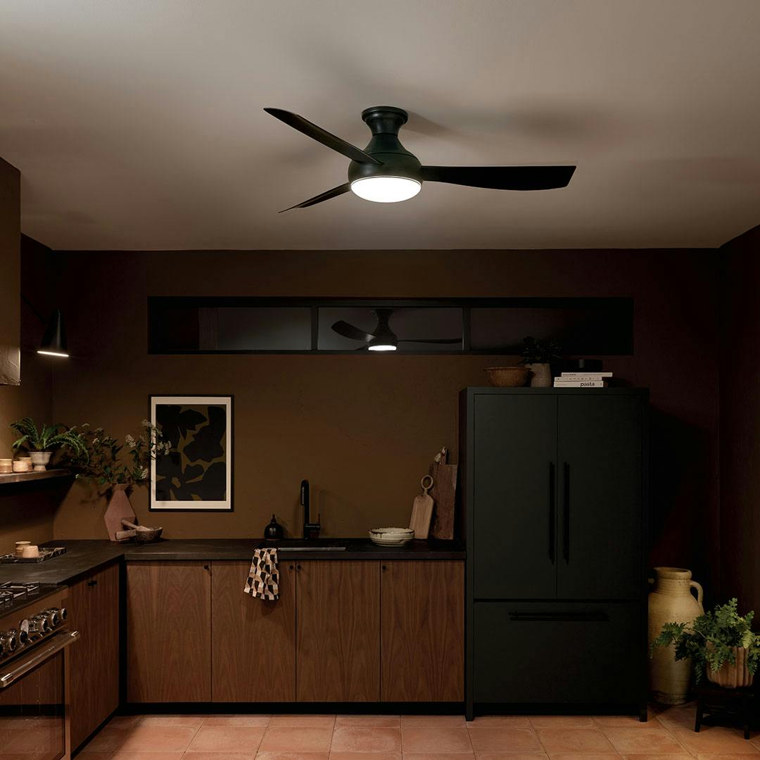 Kitchen at night with the 54 Inch Ample Ceiling Fan with Satin Etched Cased Opal Glass in Satin Black with Satin Black Blades
