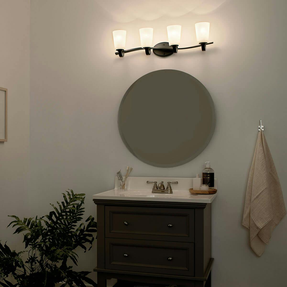 Night time Bathroom featuring Oxby vanity light 37518BK