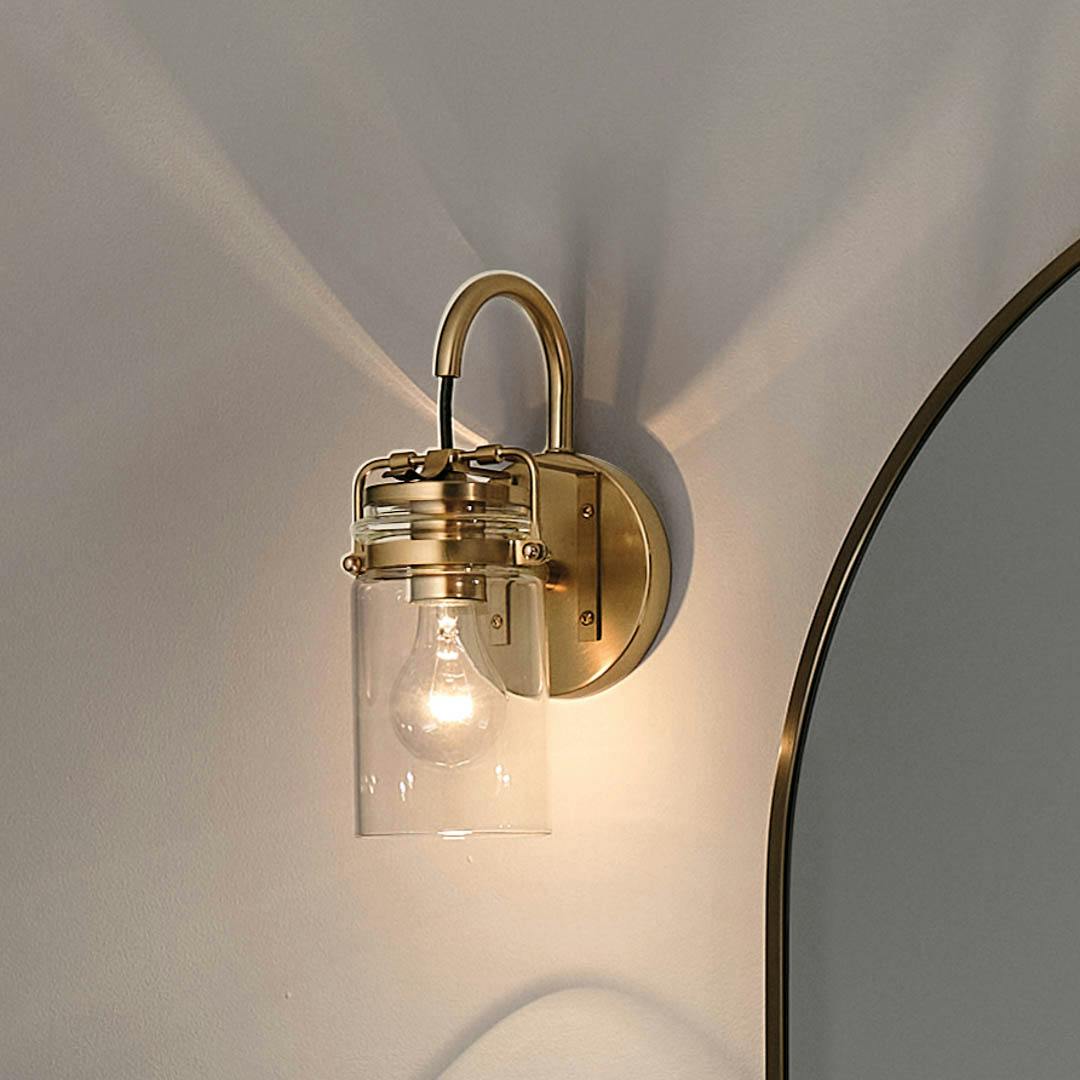 Night time bathroom with Brinley 11.5" 1 Light Wall Sconce Champagne Bronze