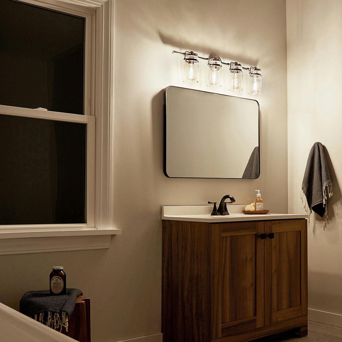 Night time Bathroom featuring Brinley vanity light 45690NI