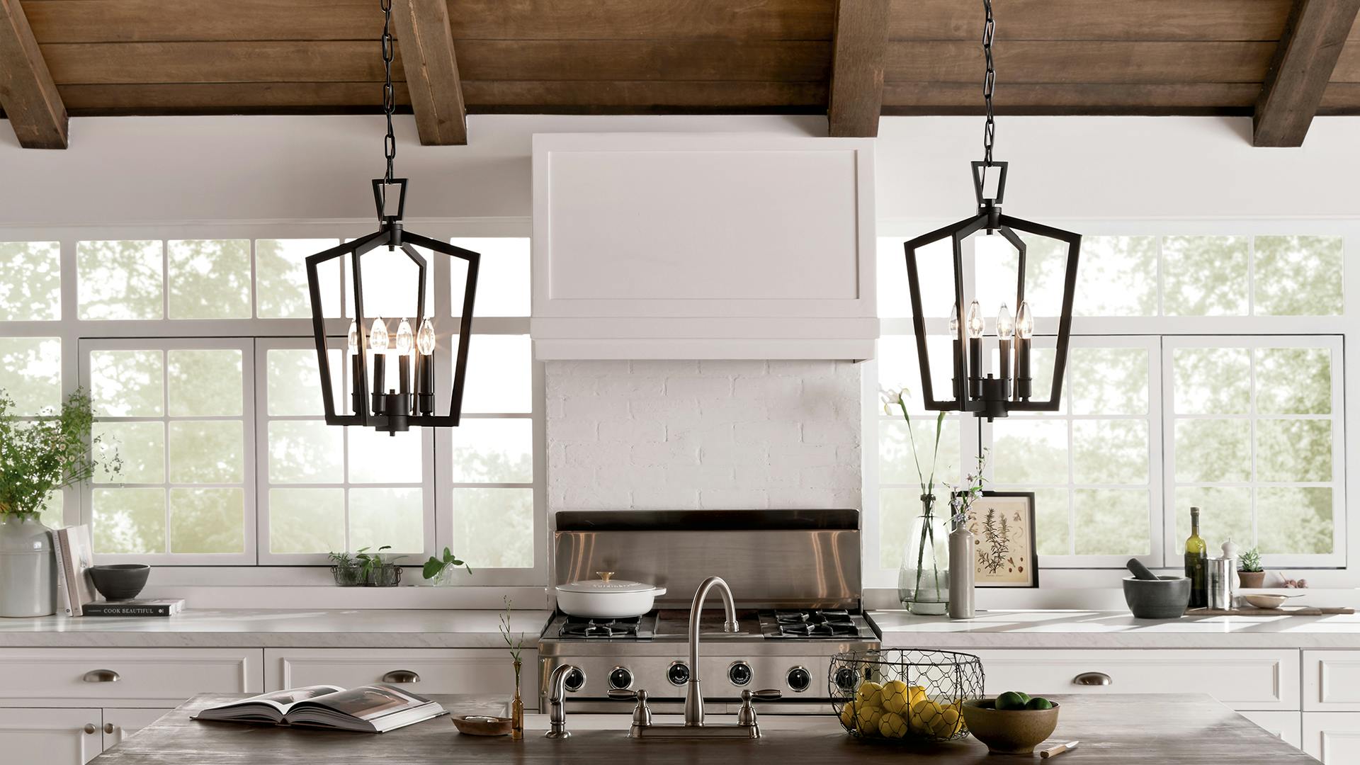 two Abbotswell pendants lit over a kitchen island