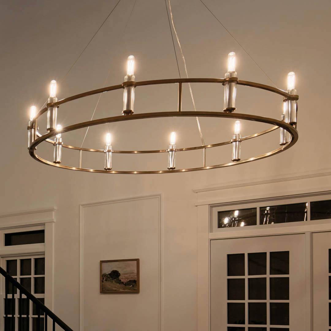 Night time foyer with Rosalind 50" 10 Light Chandelier Brushed Natural Brass