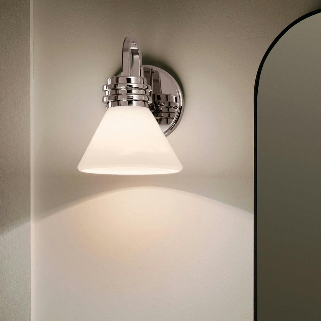 Night time bathroom with the Farum 9.5 Inch 1 Light Wall Sconce with Opal Glass in Chrome
