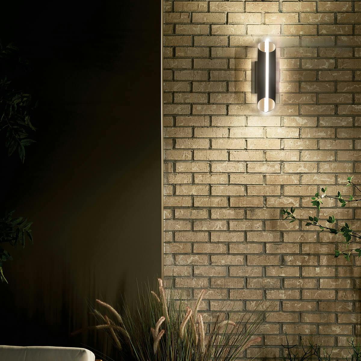 Night time exterior with Astalis™ 16" LED Wall Light with Clear Ribbed Glass Textured Black and Burnished Gold