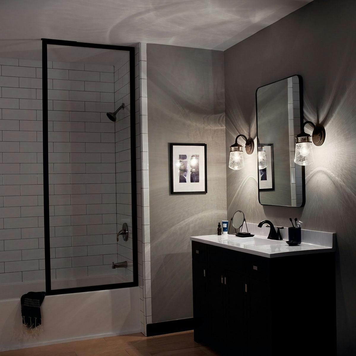 Night time Bathroom featuring Lyndon vanity light 49444AZ