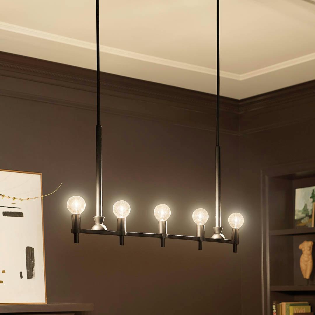 Night time dining room with Torvee 41 Inch 5 Light Linear Chandelier in Black