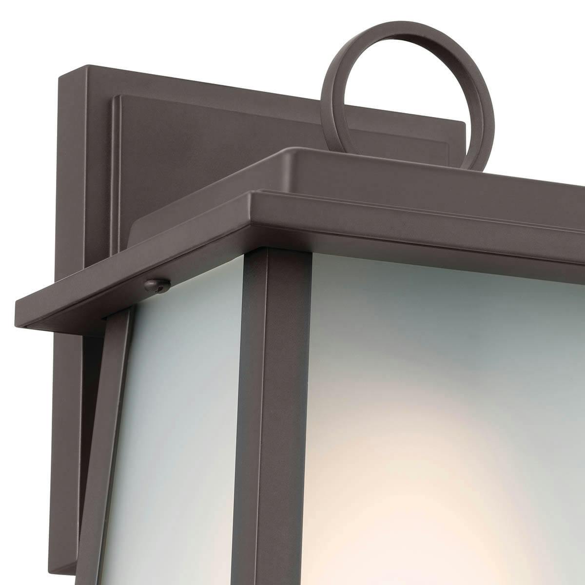 Close up view of the Noward 9" 1 Light Wall Light Olde Bronze® on a white background