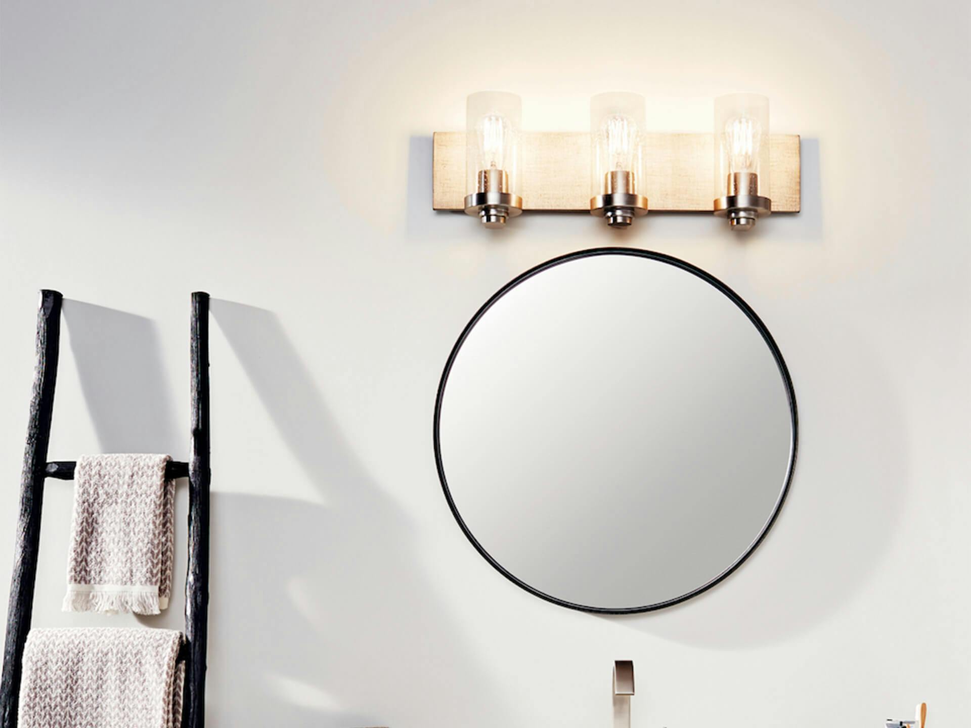 Close up shot of a mirror with a Dalwood vanity light turned on during the day 