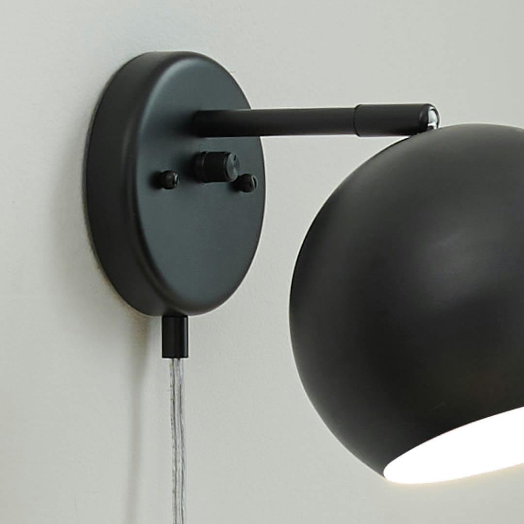 Day time reading nook with Lemmy 7.5 Inch 1 Light Plug-In Wall Sconce in Matte Black