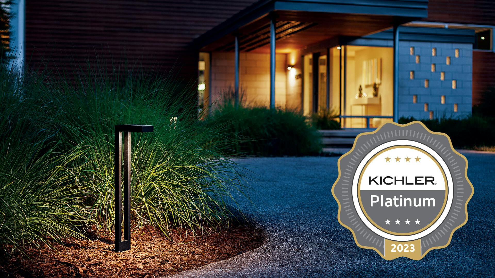 Residential landscape at night with a garden path light and featuring a Kichler Platinum 2023 Medal