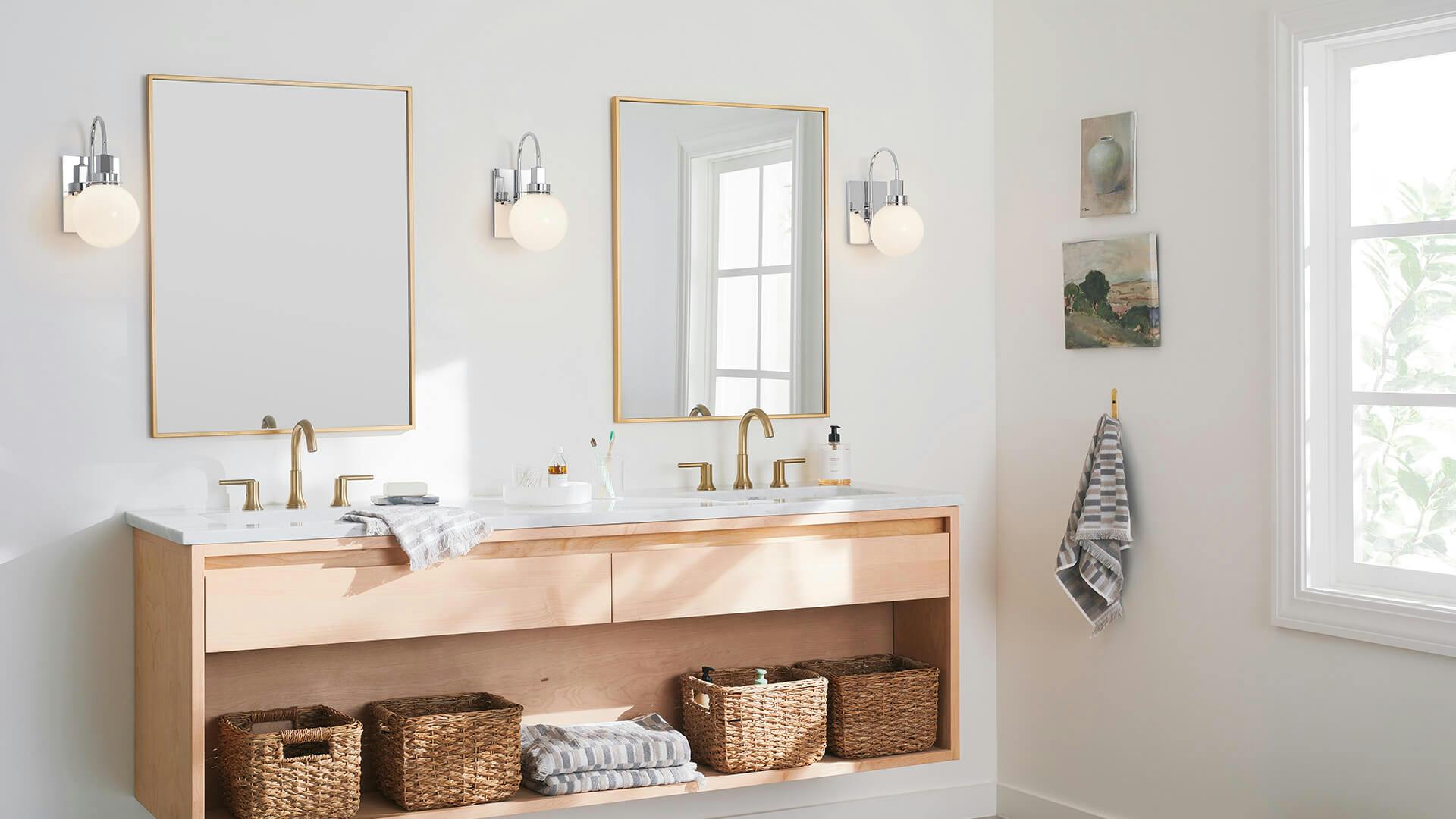 White bathroom with double vanity and 3 chrome Hex wall sconces centered between 2 mirrors