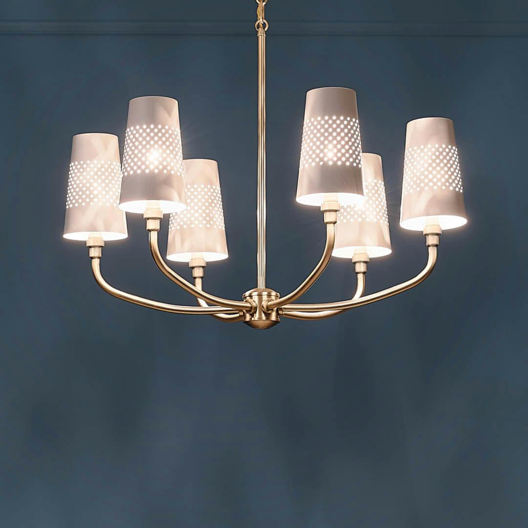 Night time dining room with Adeena 26.75" 6 Light Chandelier Brushed Natural Brass