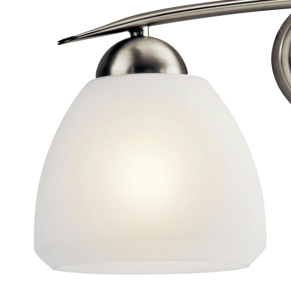 Close up view of the Calleigh 3 Light Vanity Light Nickel on a white background