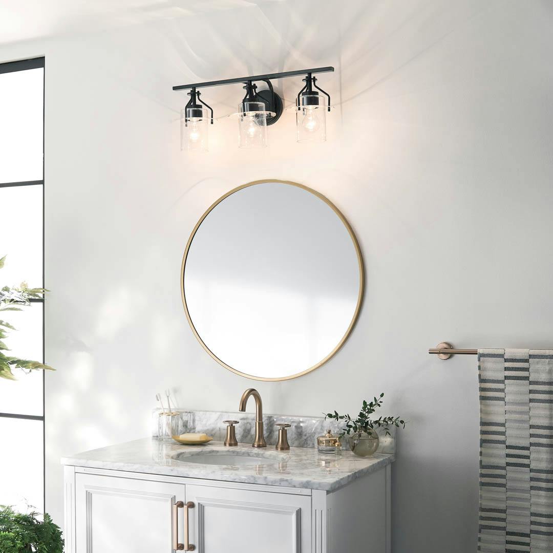 Day time bathroom with Everett 24 Inch 3 Light Vanity Light with Clear Glass in Black