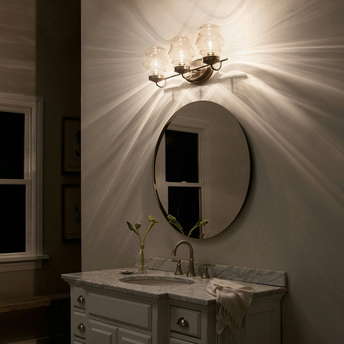 Night time Bathroom featuring Janiel vanity light 55039CLZ