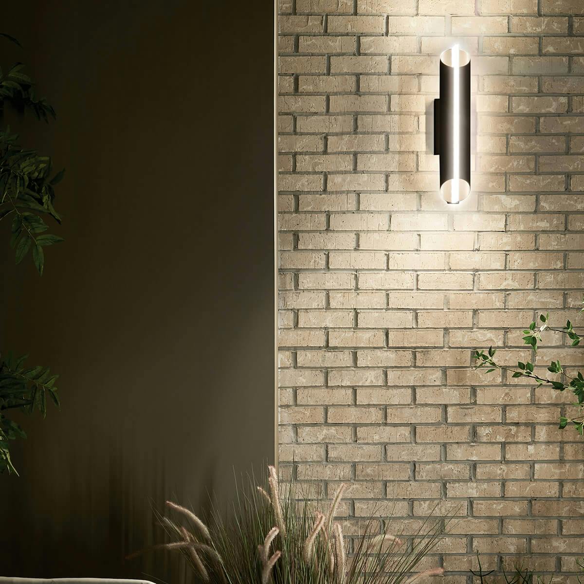Night time exterior with Astalis™ 21" LED Wall Light with Clear Ribbed Glass Textured Black and Burnished Gold