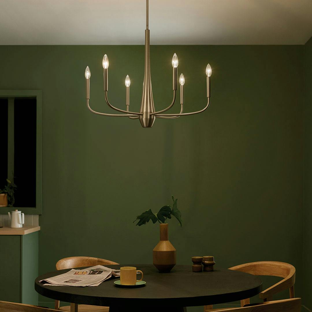 Night time dining room with the Deela 28 Inch 6 Light Chandelier in Champagne Bronze