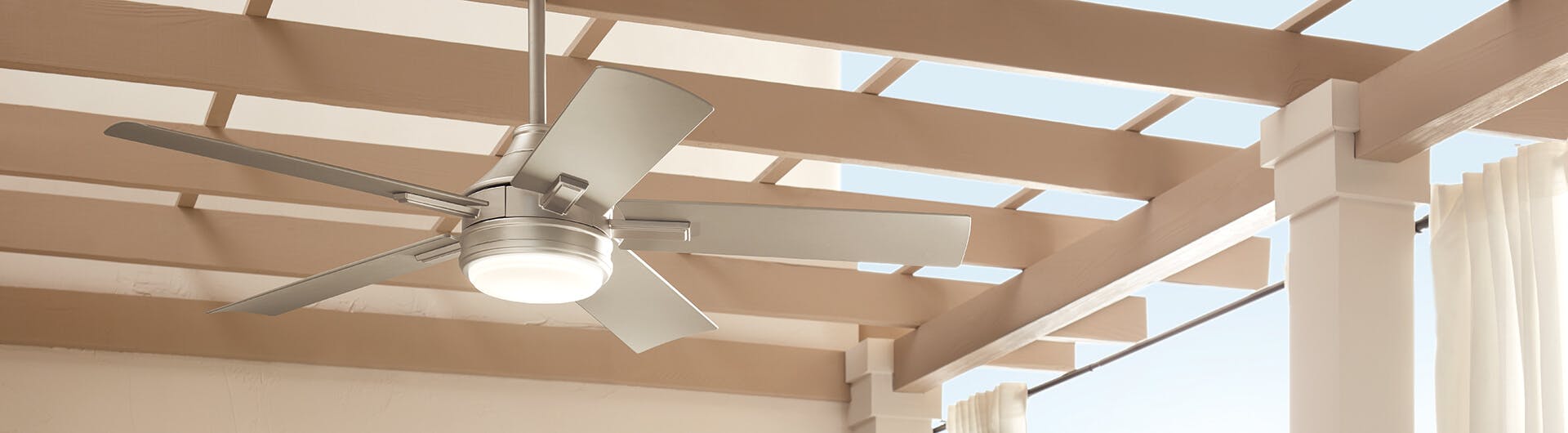 A Tide ceiling fan hiding from a wooden outdoor structure