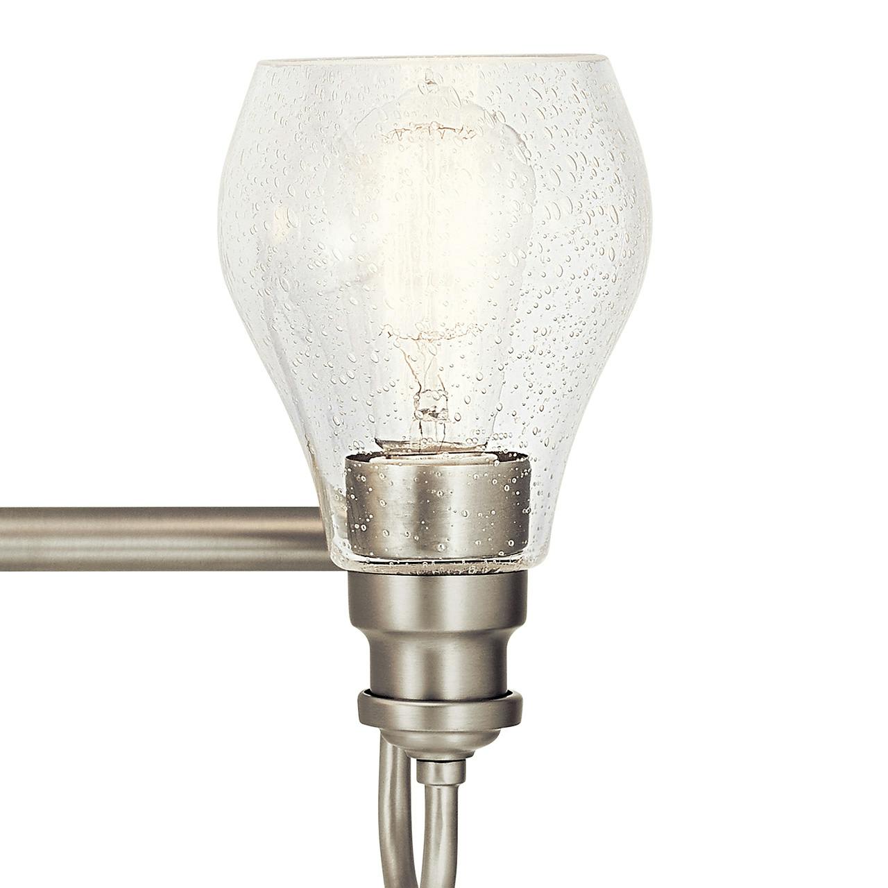 Close up view of the Greenbrier™ 4 Light Vanity Light Nickel on a white background