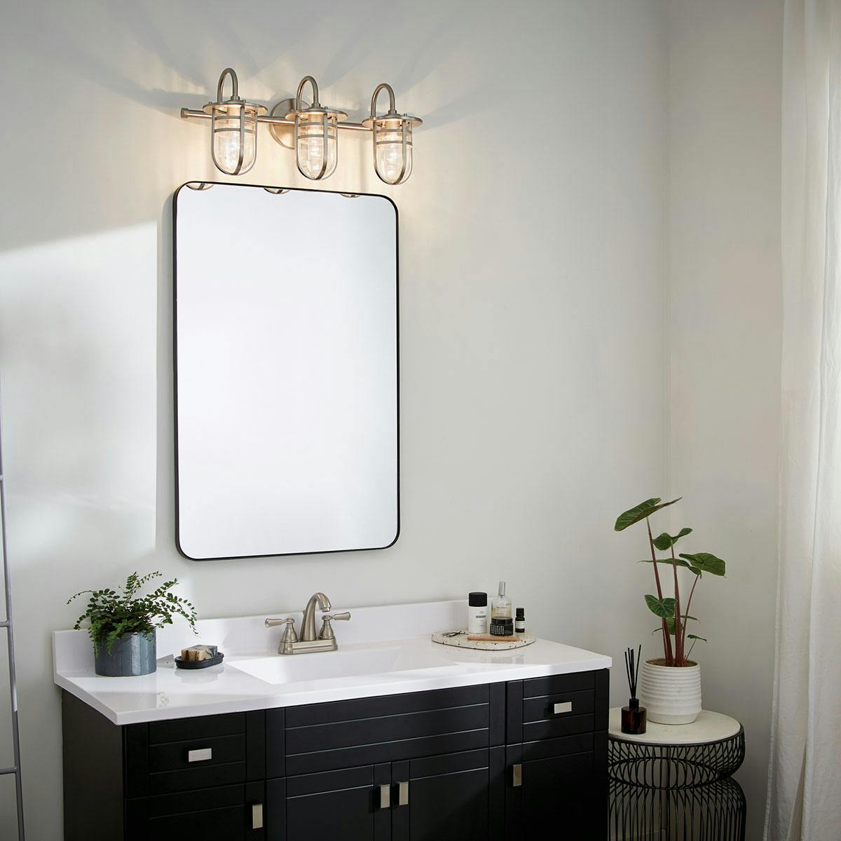 Day time Bathroom featuring Caparros vanity light 45133NI